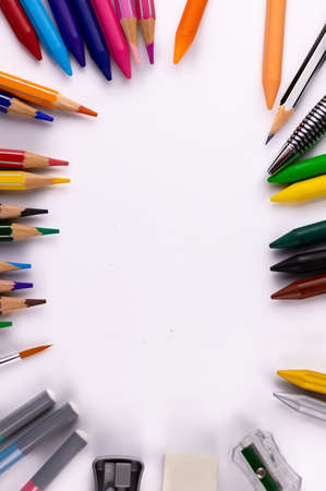 Portrait mode top shot of colors and other stationary items on white background -Study conceptの写真素材