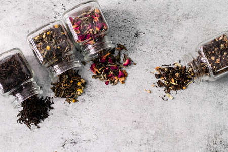 Top shot of dry tea filled in glass jars and copy spaceの写真素材