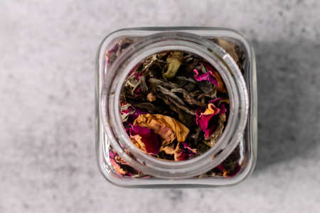 Extreme close up shot of dry rose petals in glass jar with defocused backgroundの写真素材
