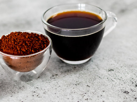 Closeup shot of black coffee with powder in glass bowl.の写真素材