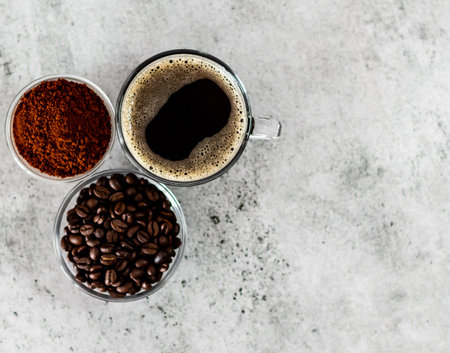 Over the top shot of coffee powder,coffee beans and black coffee arrangement with copy space.の写真素材