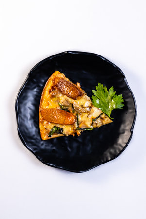 Top view of yummy Pizza slice in black plate and kept it on white surfaceの写真素材