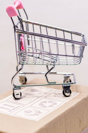 Close up shot of cart placed on fragile box in portrait orientationの写真素材