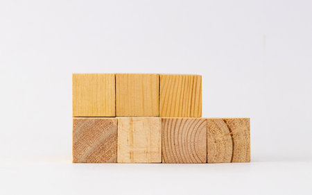 Seven blank wooden block in two rows shot against white background for templates.の写真素材