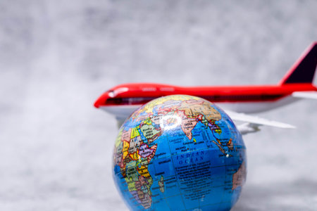 Close up shot of globe with defocused plane in the background.の写真素材
