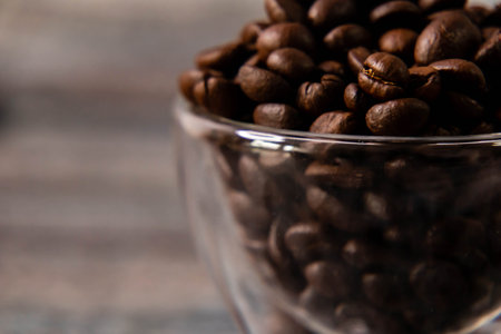 Close up shot of coffee beans in glass bowl with defocused background.の写真素材