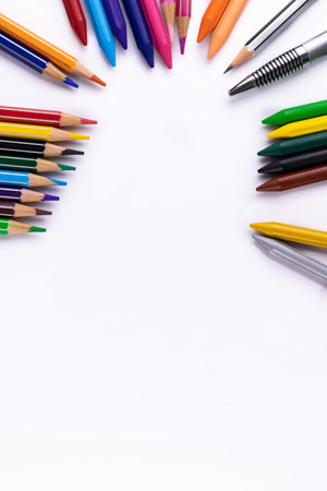 Scattered colors, pencil, and pen on white paper shot from the top -stationery conceptの写真素材