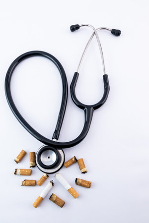 High-angle shot of stethoscope with cigarette butts - stop smoking concept.の写真素材
