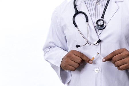 Doctor breaking cigarette on white background with copy space.の写真素材