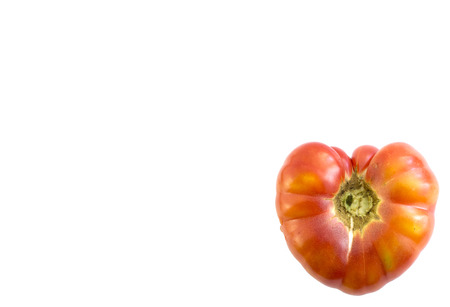 tomato in heart shape on white background with spacing for captionの写真素材