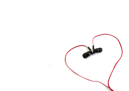red earphone setting in heart shape and spacing for captionの写真素材