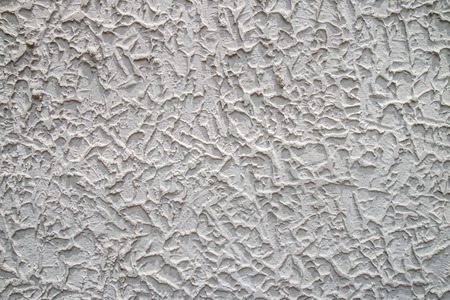 A concrete wall with a rough surface.