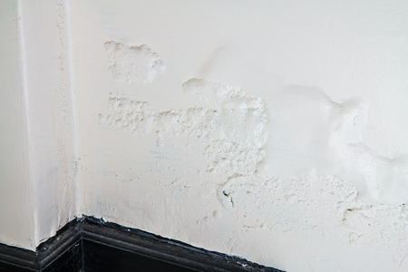 new wall with white paint peeling offの写真素材