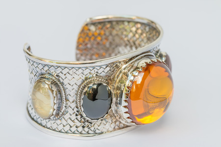Macro image, old silver bangle with gemstone, on a white Background.Handmadeの写真素材