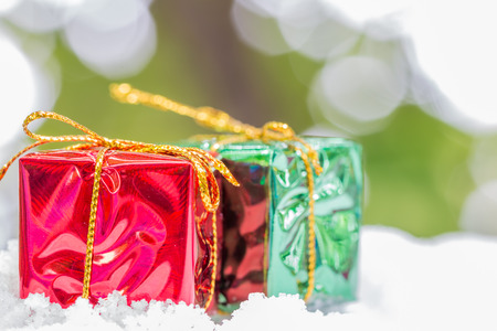 Christmas background with red and green gift boxes on abstract background, with space for text.