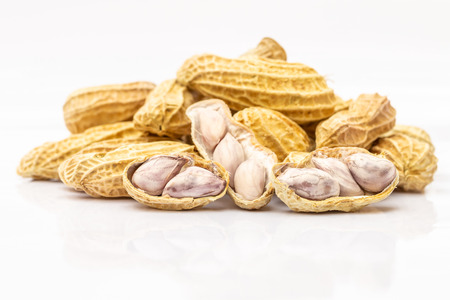 Pile of boiled peanuts on a white background, delicious and healthy eating, macro image.