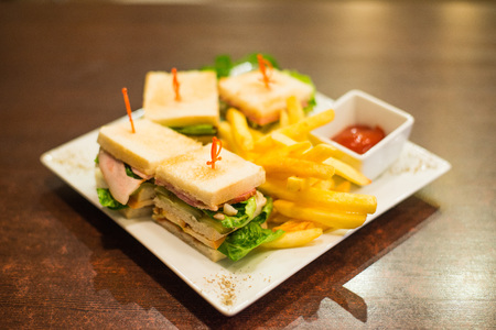 Mini sandwiches with fried fries and sauce on a white plateの写真素材