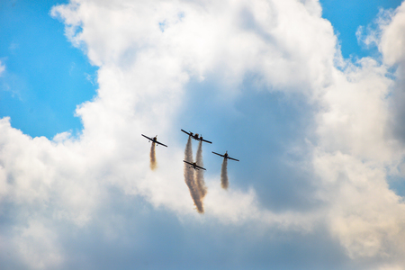 planes flying in blue sky leavin a trailの写真素材