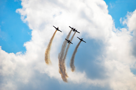 planes flying in blue sky leavin a trail