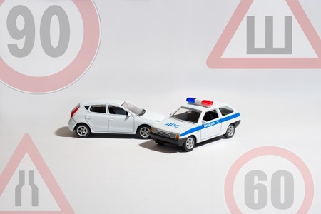 the car and the police car with the signs of restrictionsの写真素材