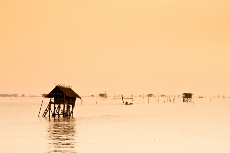 Group of  fisherman huts in the sea at dawn の写真素材