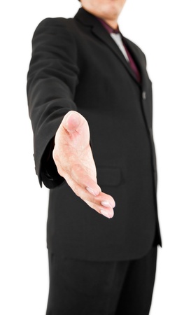 A man in black suite reaching out to shake your handの写真素材