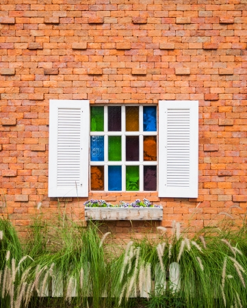 The white window with flower bed on brick wallの写真素材