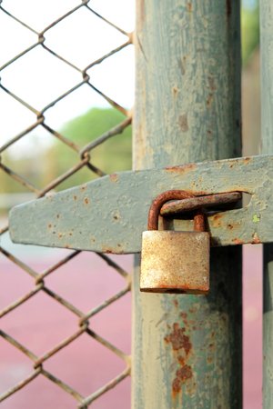 Old bolt and padlock on the door tennis courtの写真素材