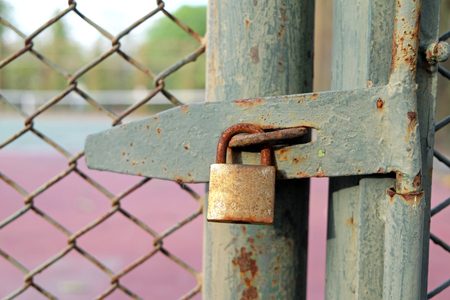 Old bolt and padlock on the door tennis courtの写真素材