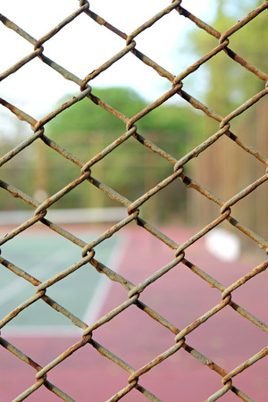 cage of blurred tennis courtの写真素材