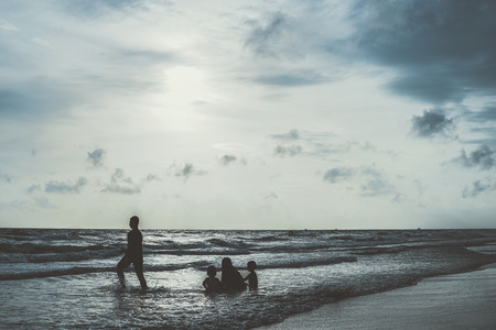 group of kids playing at the beach blur background