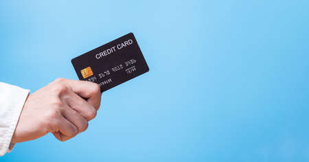 Banner advertisement of hand holding credit card for cashless payment or online shopping with copy...