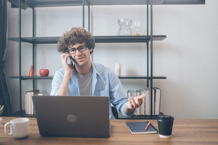 Creative designer or business entrepreneur talking on the phone to dealing with customer and checking customer order at home. Work remotely conceptの写真素材