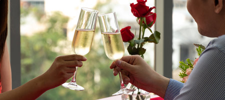Silhouette couple hand toasting glasses of champagne celebrating on Anniversary, New Year, birthday or Valentine's day. Dinner dating together at home.の写真素材