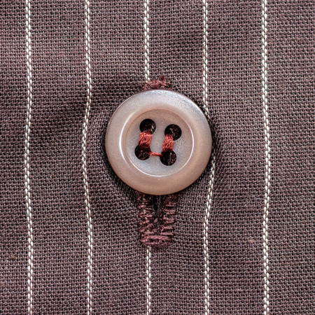 Close up a button from a shirt.