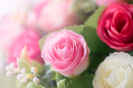 Beautiful Decoration artificial rose flower in pink tone background.の写真素材