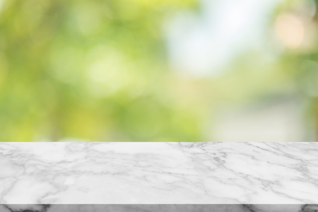 White marble stone table top on blur green background from nature, can be used for display or montage your productsの写真素材