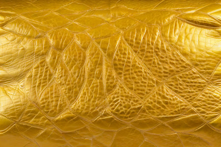 Beautiful golden background with leather texture. Gold leather as sample of gold background from natural leather. generative ai.の素材