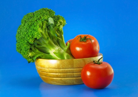 broccoli with tomatoes on blueの写真素材