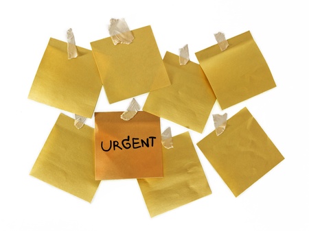 note urgent on yellow paperの写真素材