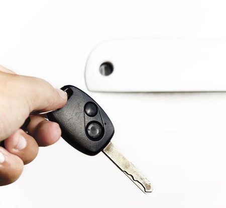 hand holding car keys over white