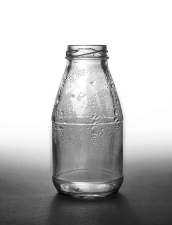 empty wet glass bottle over whiteの写真素材