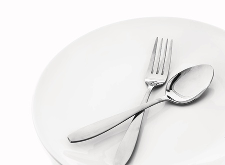 plate with spoon and fork on whiteの写真素材