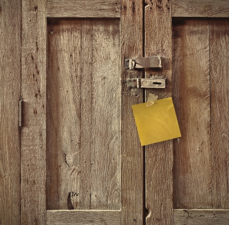 note paper on antique wooden doorの写真素材