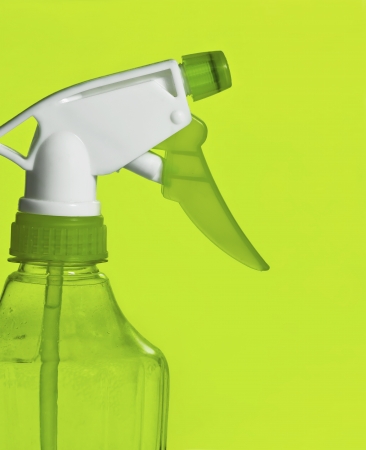 spray clean bottle over green backgroundの写真素材