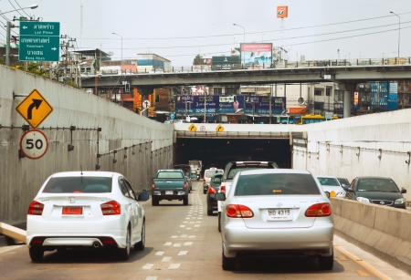 BANGKOK - MARCH 30: a new car on street moving into the tunnel on March 30, 2013 in Bangkok, Thailand. Traffic in Bangkok is getting worse because the government's first-car tax-rebate policy.のeditorial素材
