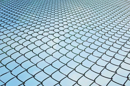 pattern of wired fence and blue skyの写真素材