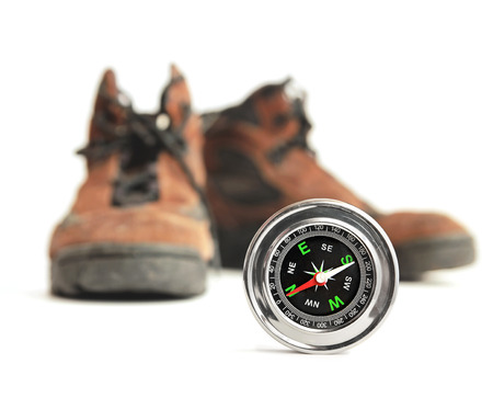 compass and hiking shoes on white backgroundの写真素材