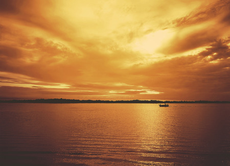 sunrise sea and fishing boat in retro color styleの写真素材