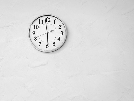 white clock on white wallの写真素材